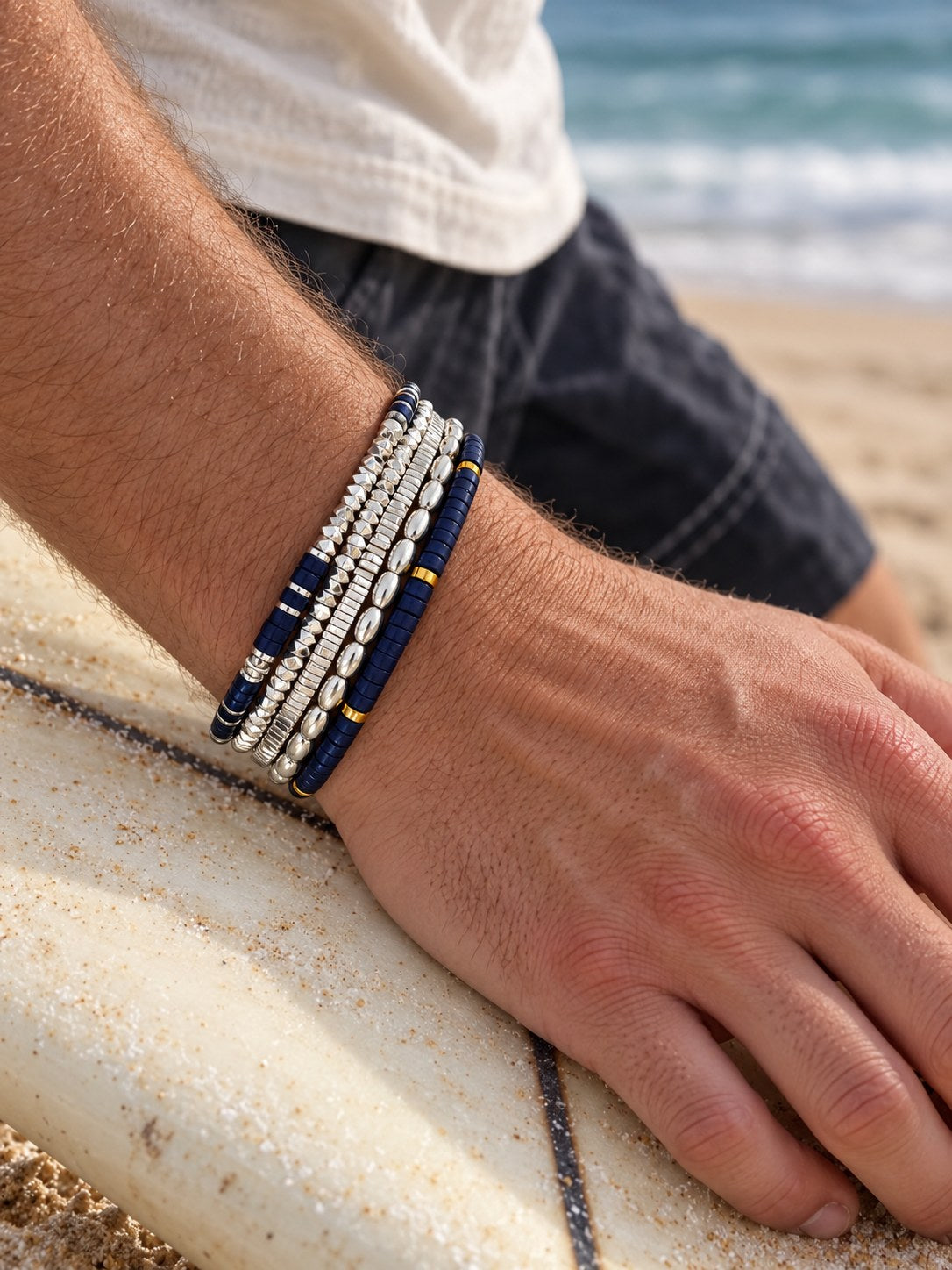 The Lapis Set on the wrist, on a surfboard